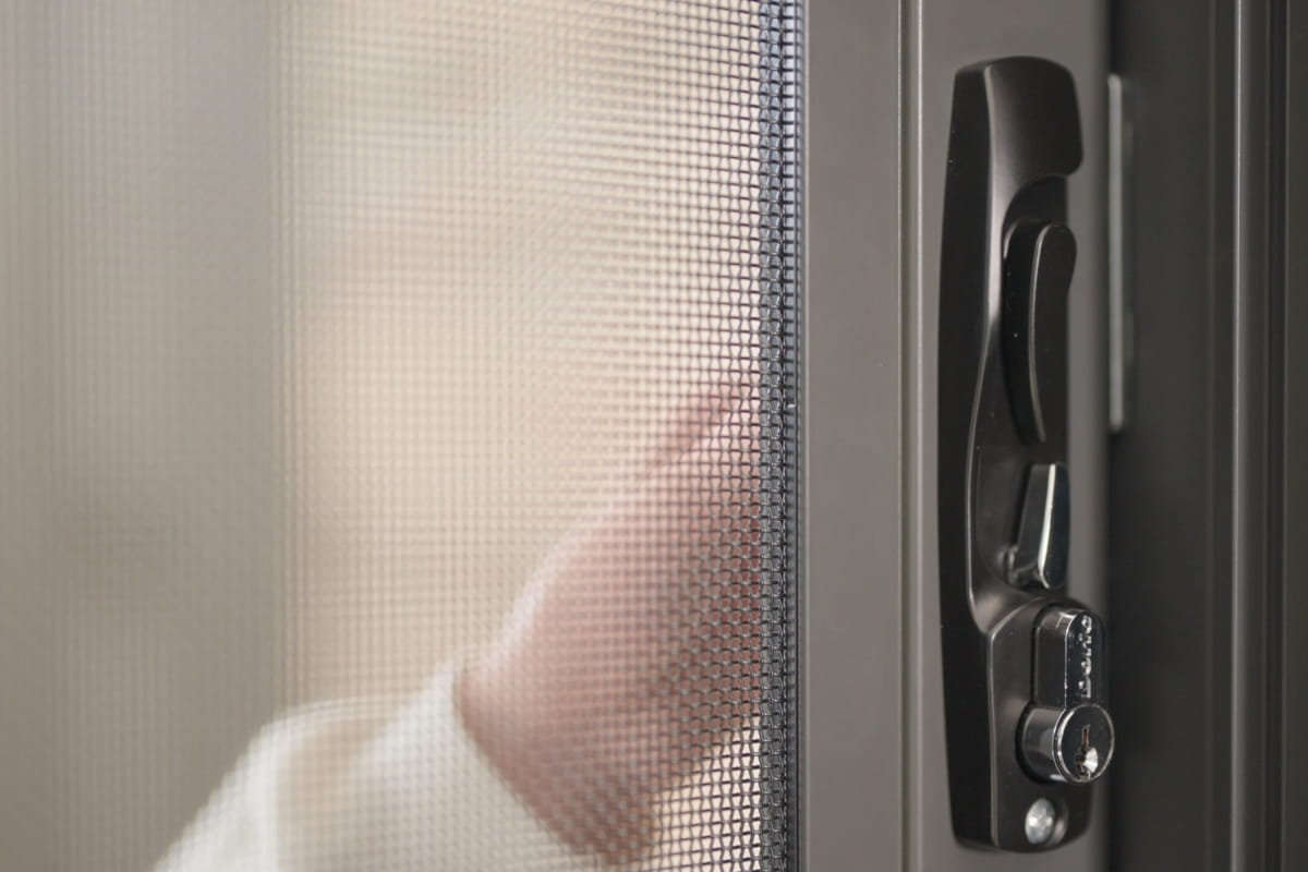 What Is a Bushfire Attack Level (BAL) and Why It Matters for Your Home 2 Amplimesh BAL-rated security screen door with a metal mesh panel and locking mechanism, designed for homes in bushfire-prone areas.