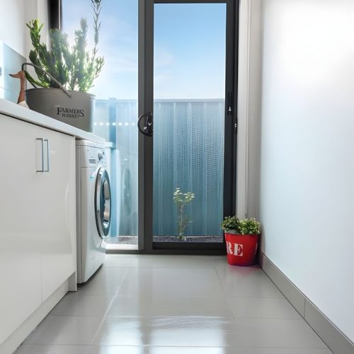 IntrudaGuard security screen door in a laundry room.