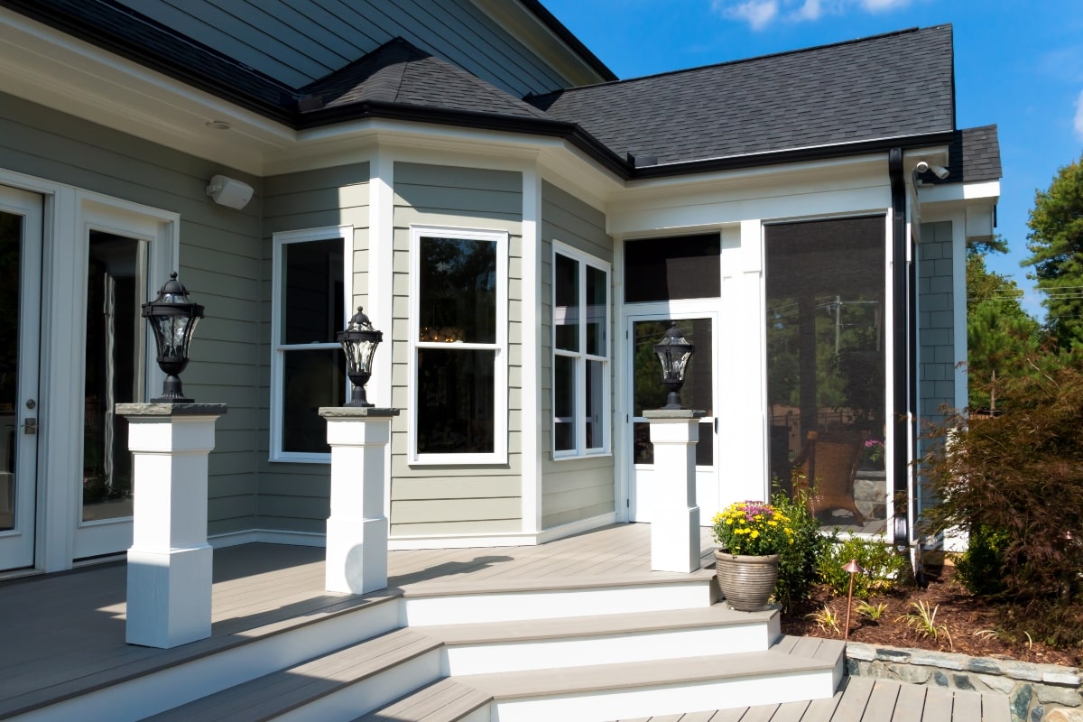 Back deck of a house, with a screened in patio area.