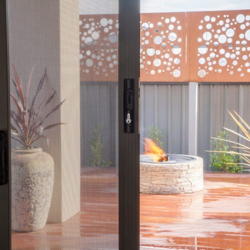 A sliding security door on the back door of a home.