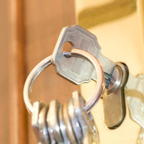 Set of keys in door lock hanging.