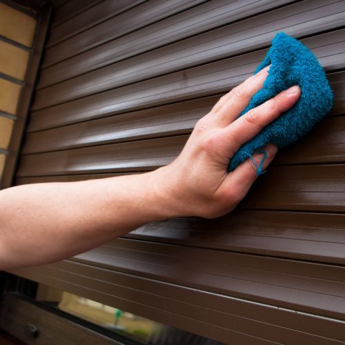 Hand cleaning set of security roller shutters.