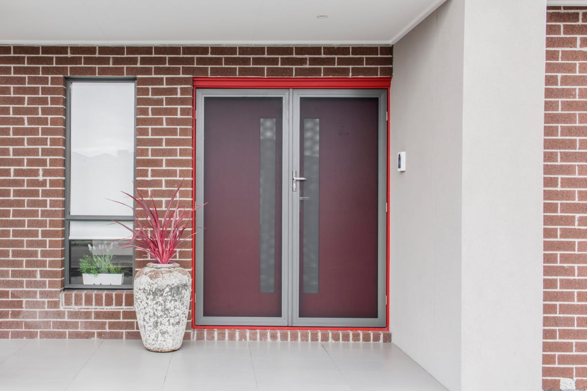 Safety Screen Door or Security Door? Don’t Risk the Wrong Choice 1 Double security screen door fitted to the entrance of a modern brick home.