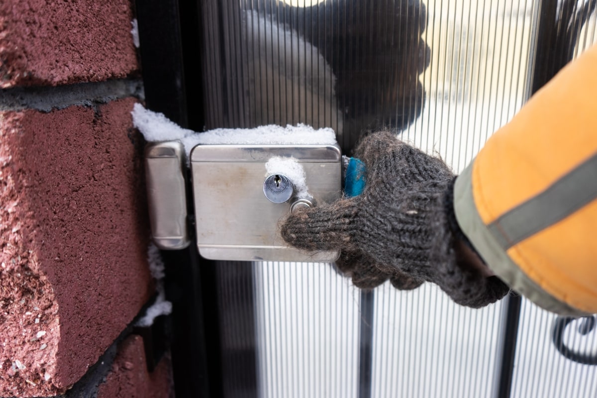 Front entrance with a frozen lock covered in snow.