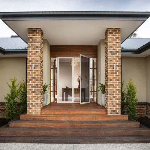 Entry to a house with hinged security doors open.