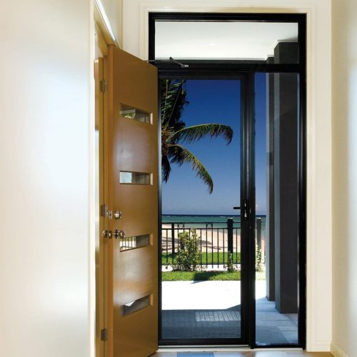 Interior of a house, looking out through a security door with a black frame.