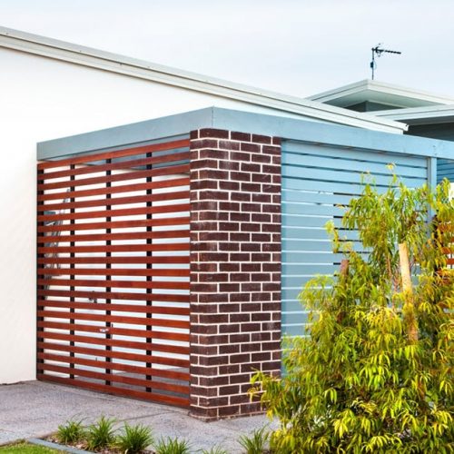 Home with privacy screens, a gate and fencing.