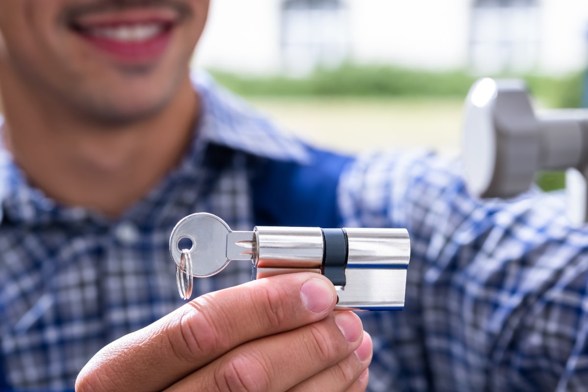 Locksmith apprentice holding lock cylinder.