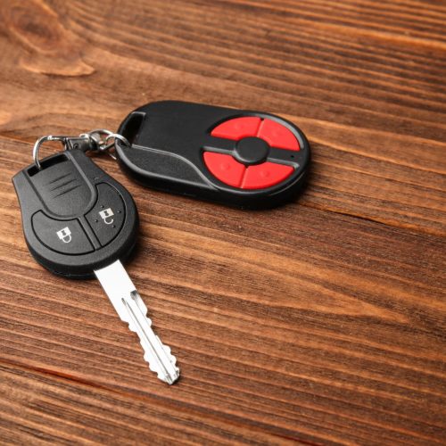 Car key replacement remote on wooden bench.