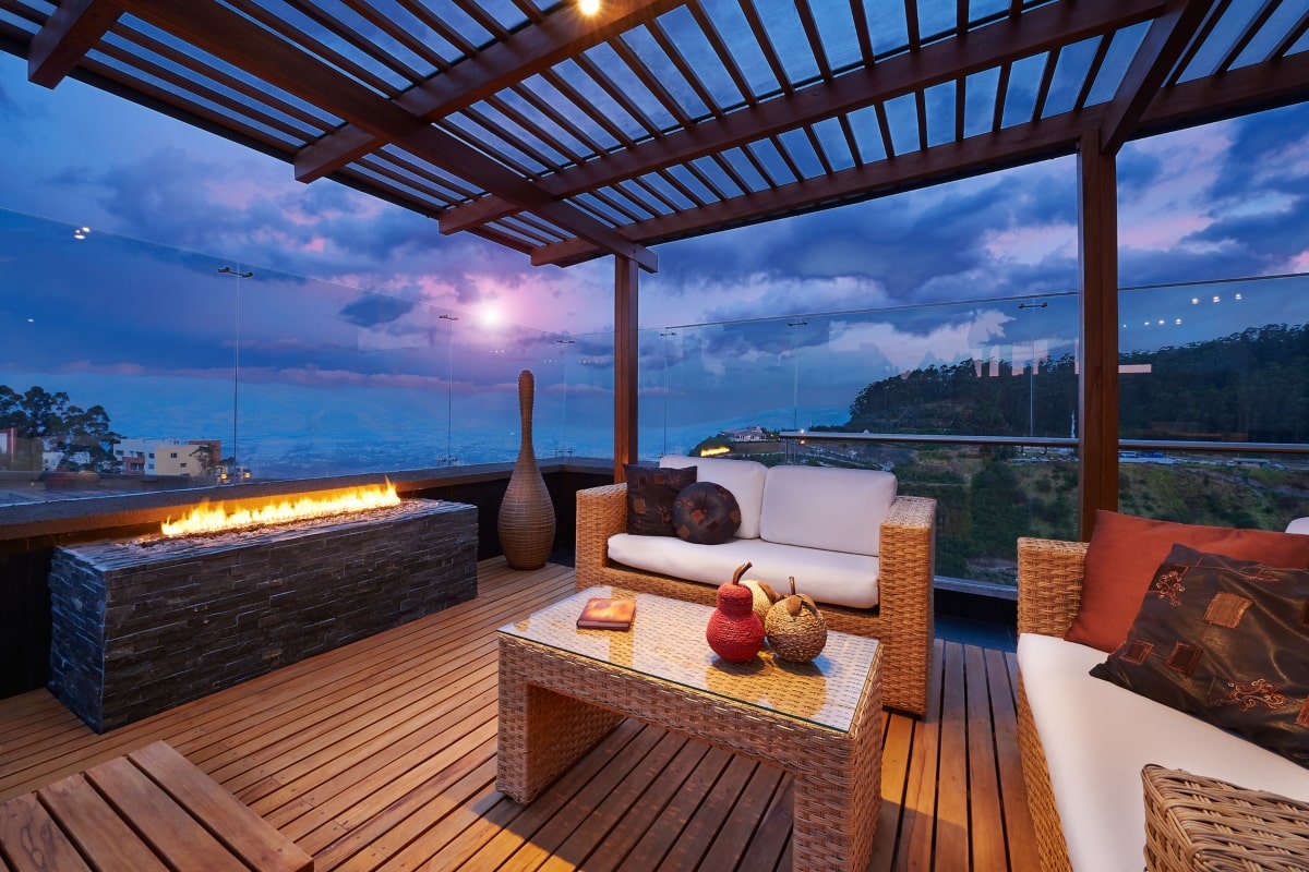 Outdoor terrace with a pergola at night.