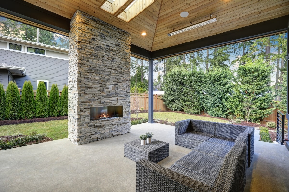 Patio desined as an outdoor living area with a fireplace.