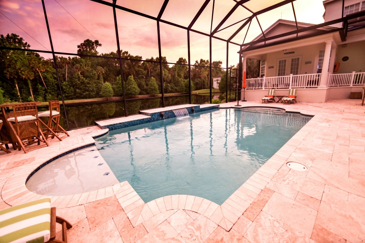 A Florida Room style pool enclosure at sunset.