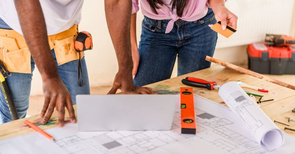 A couple planning the budget they're willing to allocate to a home renovation.