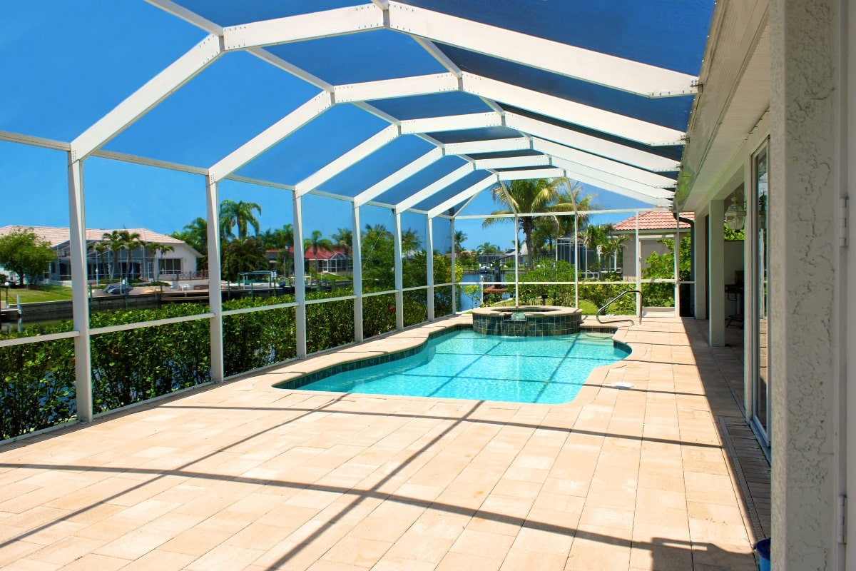 Screened-in pool with a spa.