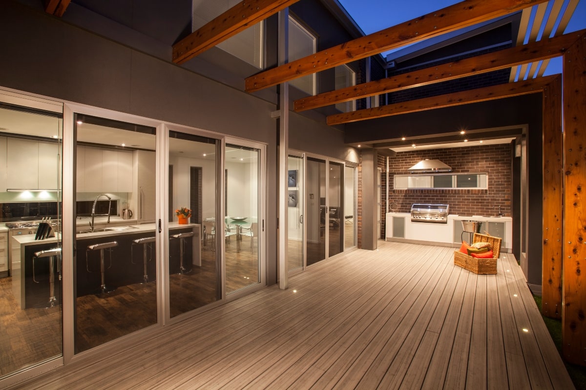 An inviting outdoor space with wooden decking complemented by outdoor patio screens, creating an uninterrupted flow from indoor to outdoor living.