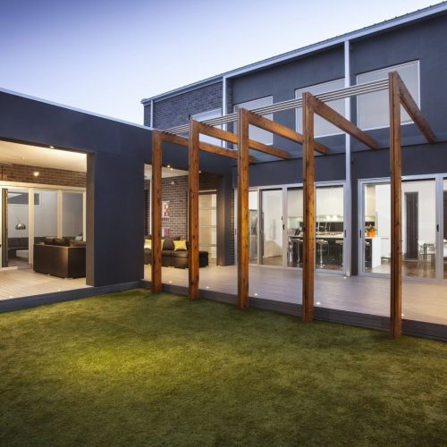 Sliding security doors along a contemporary alfresco area, connecting indoor living with the backyard.