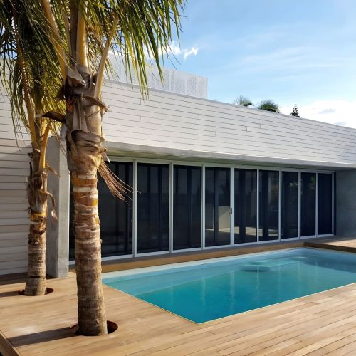 Stacking security doors with an outdoor pool area.