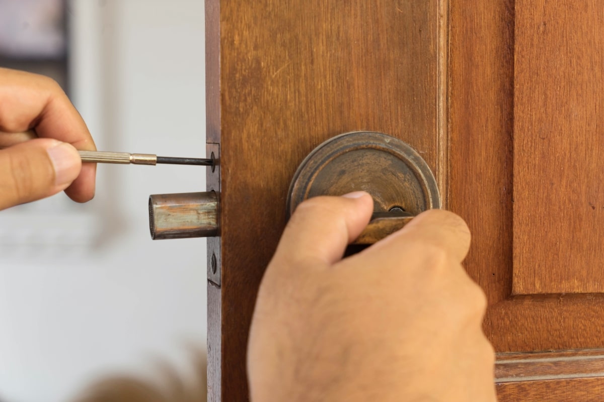 Repairing an old, worn out lock in wooden door.